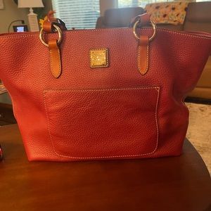 Gorgeous Leather Dooney Bourke! Has red fabric interior, center zip pocket